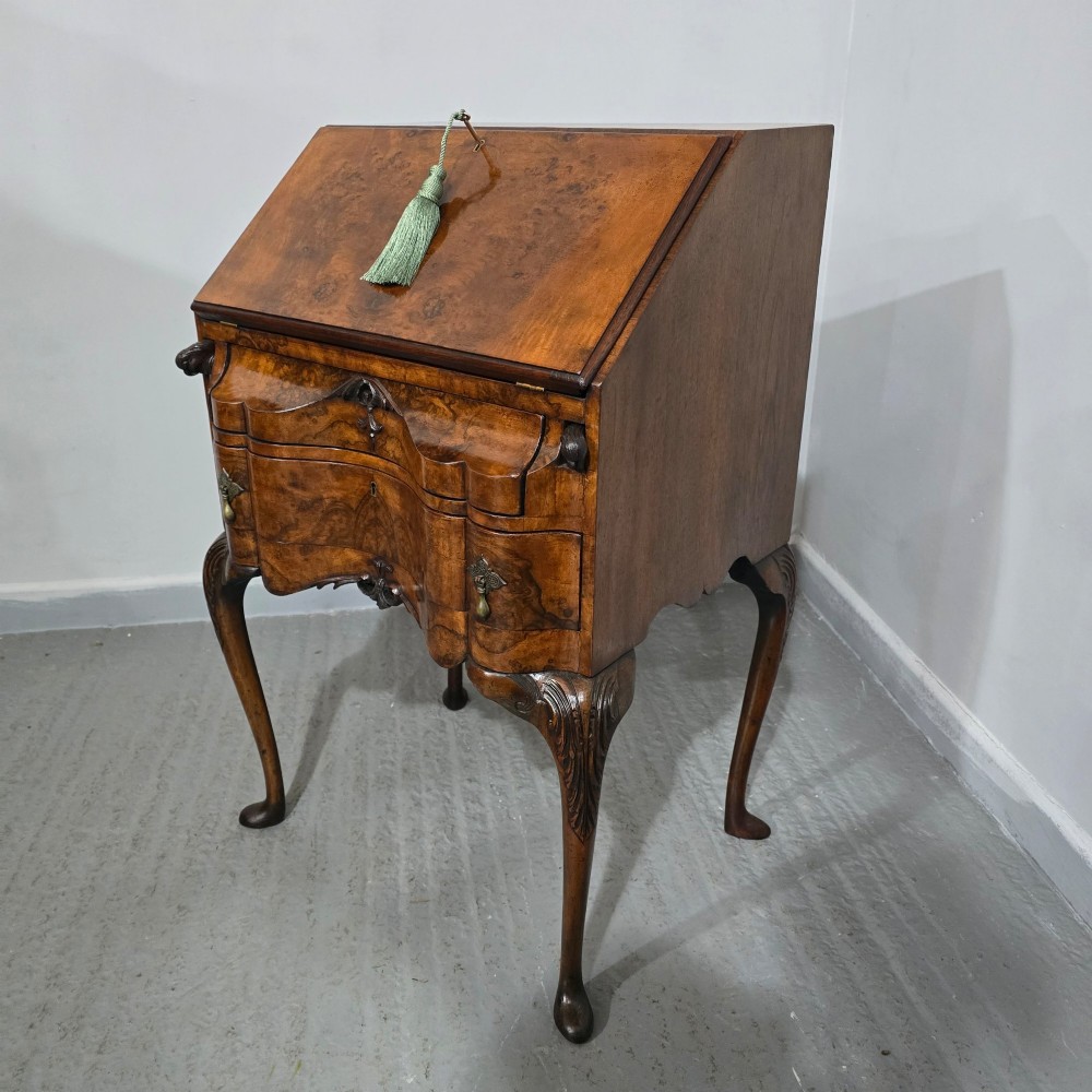 A Queen Anne style burr walnut writing bureau featuring a sloped front lid, shaped drawers with brass drop handles, and tall cabriole legs. View XIII