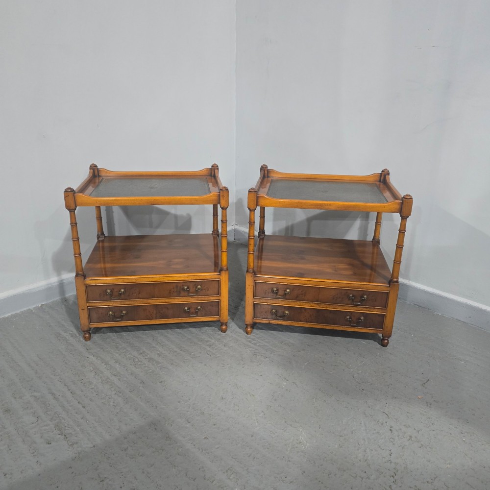 A pair of yew wood lamp tables featuring dark green leather inset tops, a middle shelf, two drawers with brass handles, and turned corner columns. View II