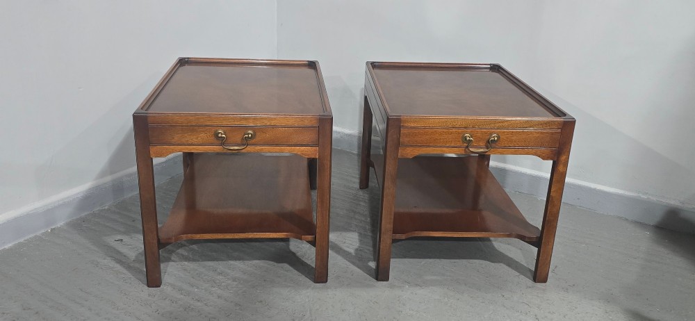 A pair of solid mahogany lamp end tables featuring tray tops, single drawers with brass handles, and lower tier shelves. View III