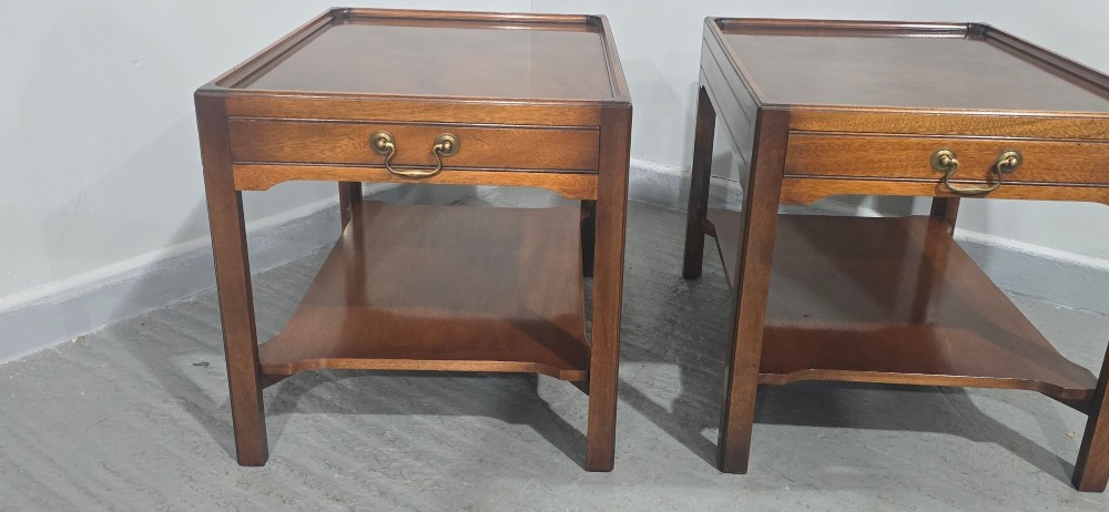 A pair of solid mahogany lamp end tables featuring tray tops, single drawers with brass handles, and lower tier shelves. View V