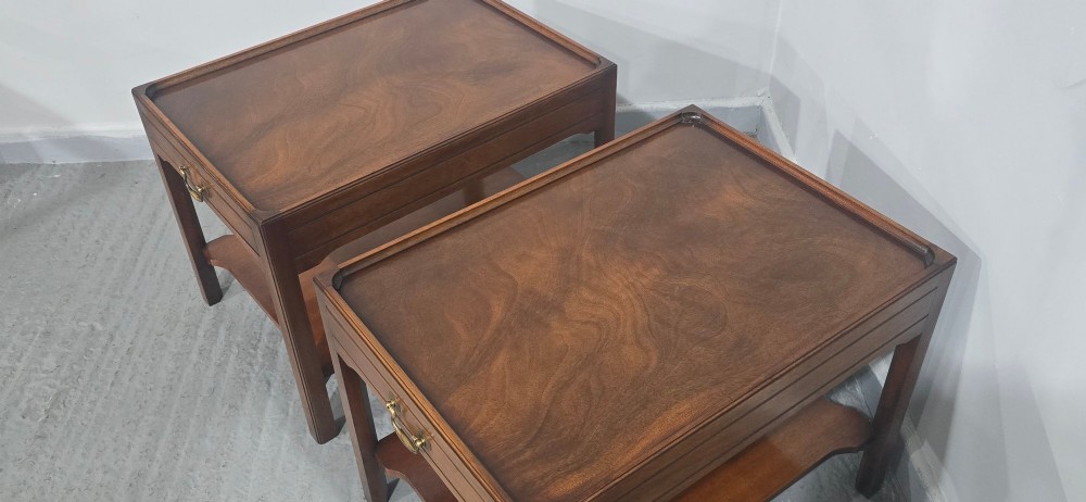 A pair of solid mahogany lamp end tables featuring tray tops, single drawers with brass handles, and lower tier shelves. View IX