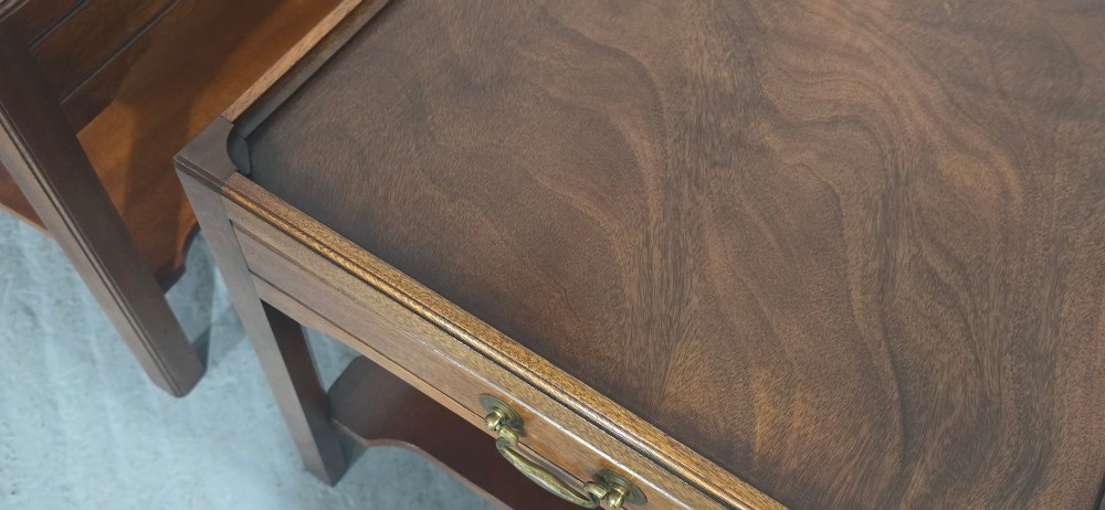 A pair of solid mahogany lamp end tables featuring tray tops, single drawers with brass handles, and lower tier shelves. View XII