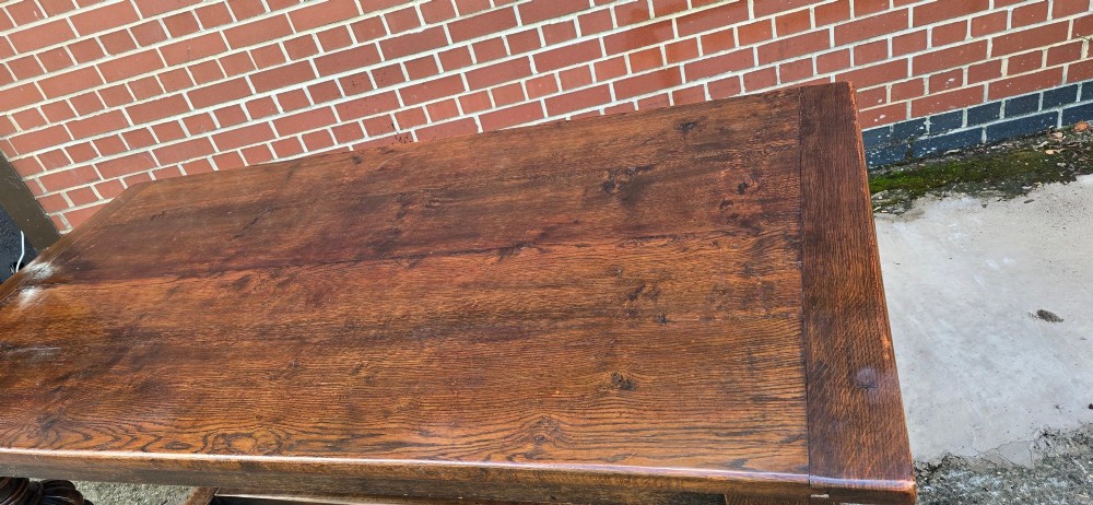 A heavy dark oak refectory dining table featuring carved cup-and-cover bulbous legs and a low stretcher base. View XIII