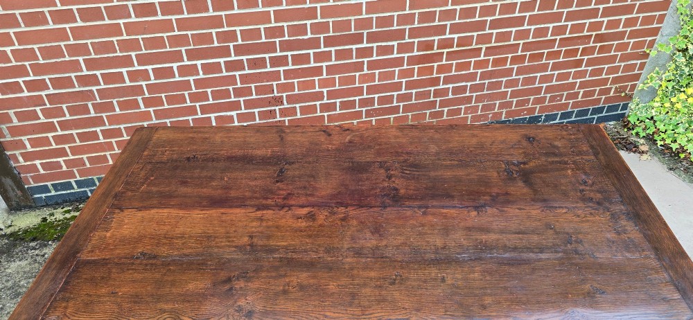 A heavy dark oak refectory dining table featuring carved cup-and-cover bulbous legs and a low stretcher base. View XIV