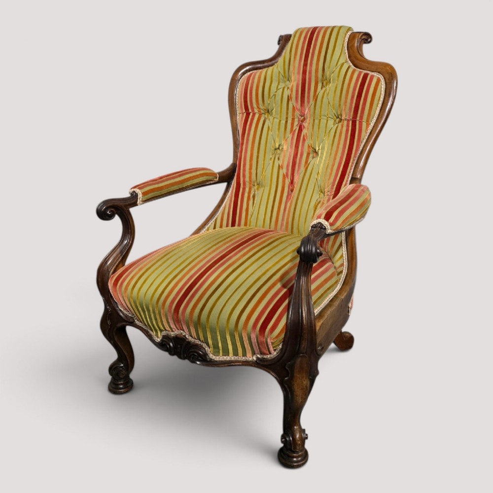 A Regency rosewood armchair featuring a button-tufted backrest, scrolled arms, carved legs, and striped green and red upholstery. View II
