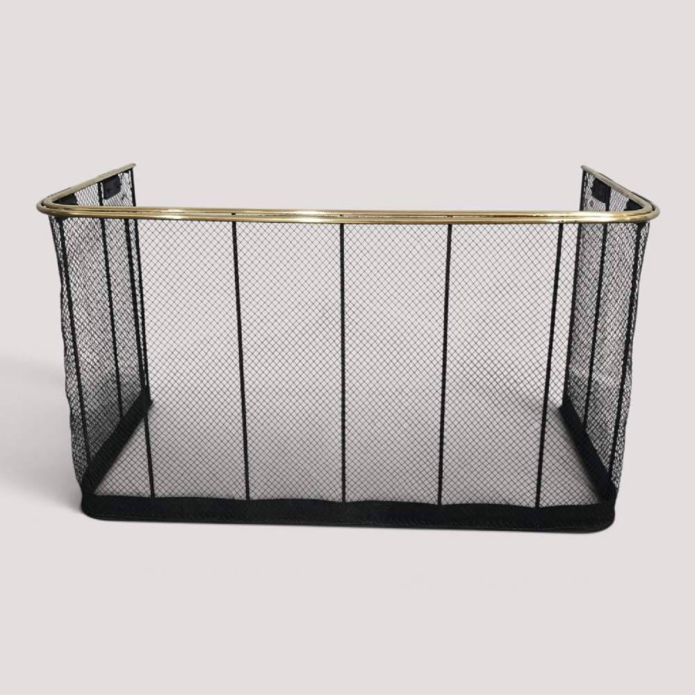 A three-sided black wire mesh fireguard featuring a polished brass rounded top rail and a solid base.
