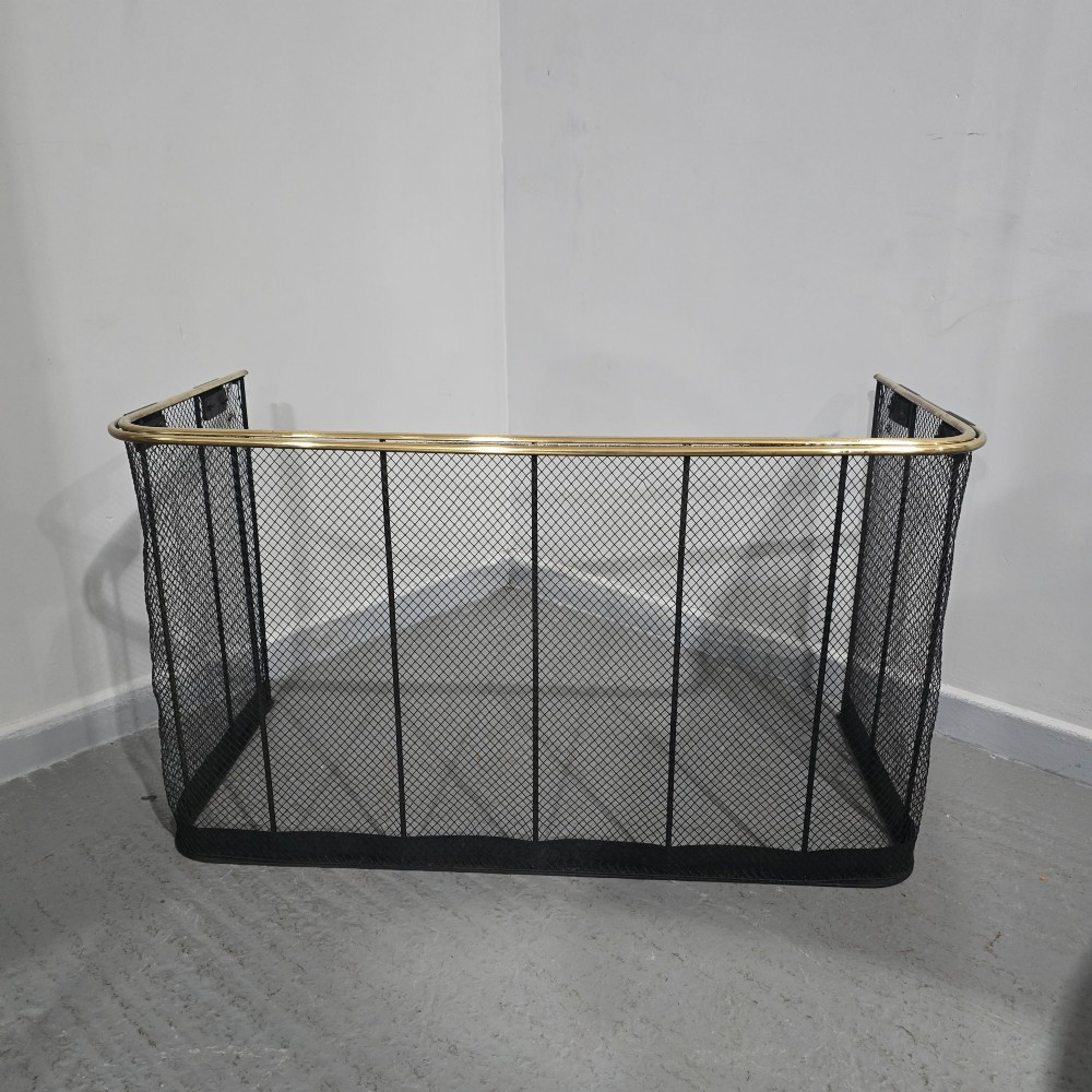 A three-sided black wire mesh fireguard featuring a polished brass rounded top rail and a solid base. View II