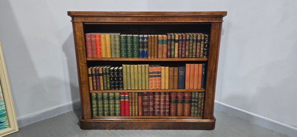 A solid mahogany Victorian open bookcase featuring adjustable internal shelves and a solid plinth base filled with books. View III