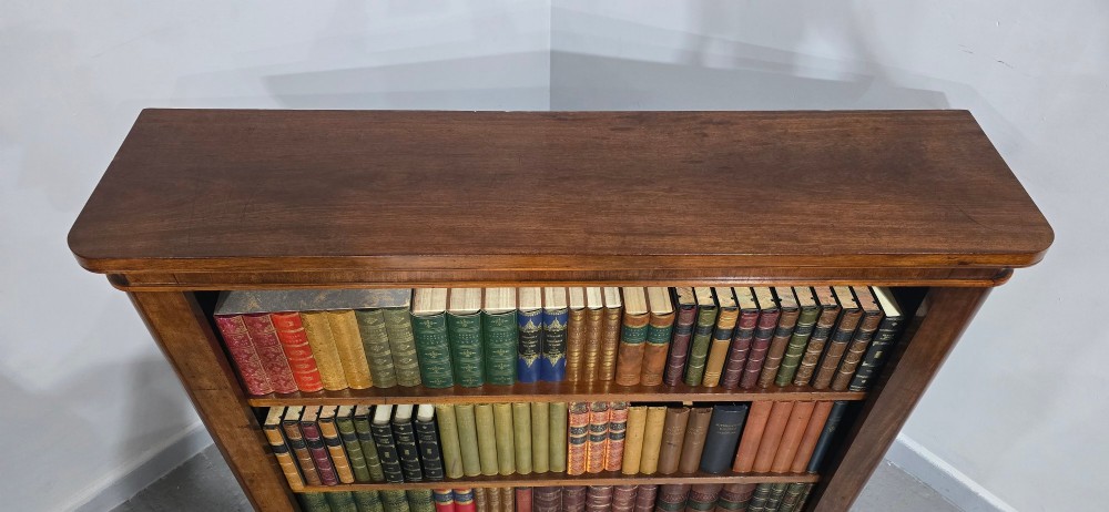 A solid mahogany Victorian open bookcase featuring adjustable internal shelves and a solid plinth base filled with books. View VII