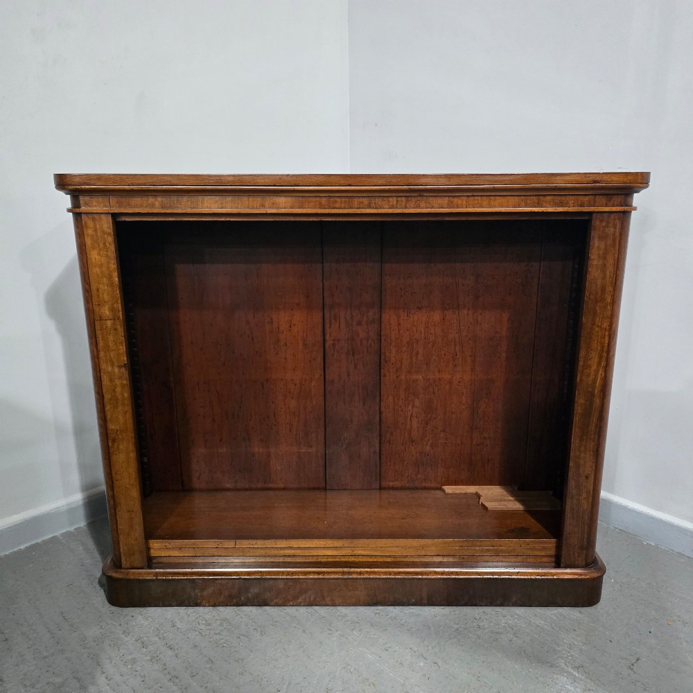 A solid mahogany Victorian open bookcase featuring adjustable internal shelves and a solid plinth base filled with books. View VIII