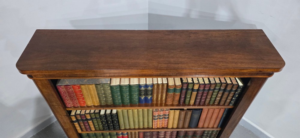A solid mahogany Victorian open bookcase featuring adjustable internal shelves and a solid plinth base filled with books. View IX