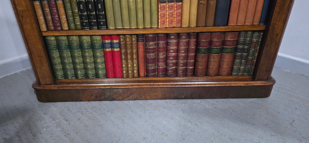 A solid mahogany Victorian open bookcase featuring adjustable internal shelves and a solid plinth base filled with books. View XI