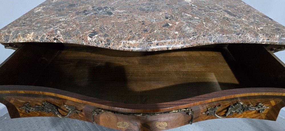 A French Louis XV style bombe commode featuring detailed floral marquetry inlay, bronze mounts, curved legs, and a brown marble top. View XIII