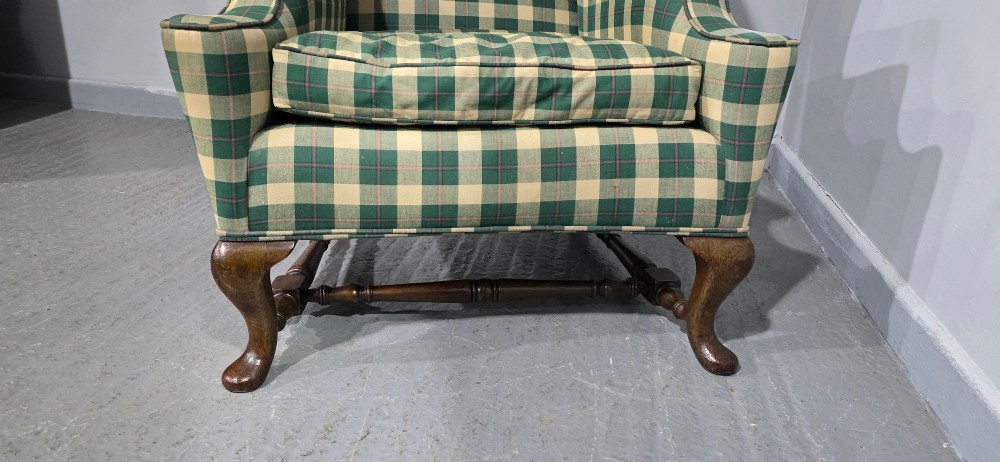 High-backed wingback armchair upholstered in green and cream check fabric with carved oak cabriole front legs. View IX