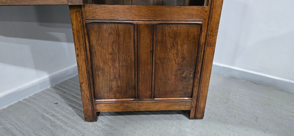 A tall, narrow antique dark oak food cupboard featuring panelled doors, hand-forged iron hinges, a metal ring drop handle, and a top moulded cornice. View XII