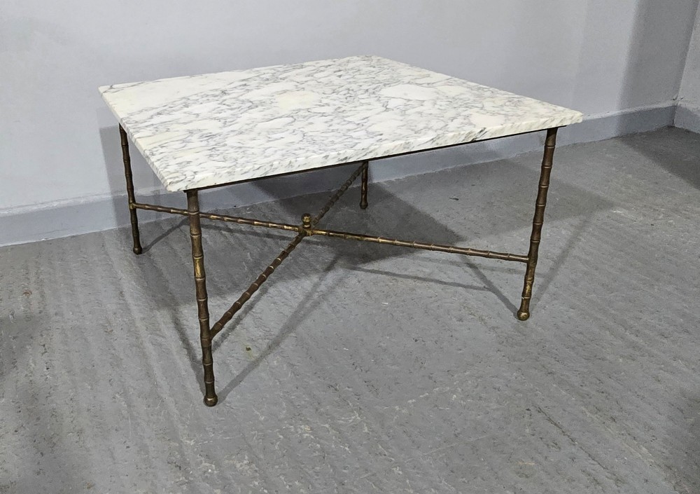 A rectangular French coffee table featuring a white veined marble top resting on a gilt brass faux-bamboo frame with an X-shaped stretcher. View VI