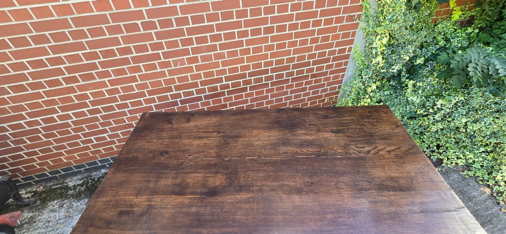 A solid warm brown French oak refectory dining table featuring a rectangular plank top, square legs, and an H-stretcher base. View IX