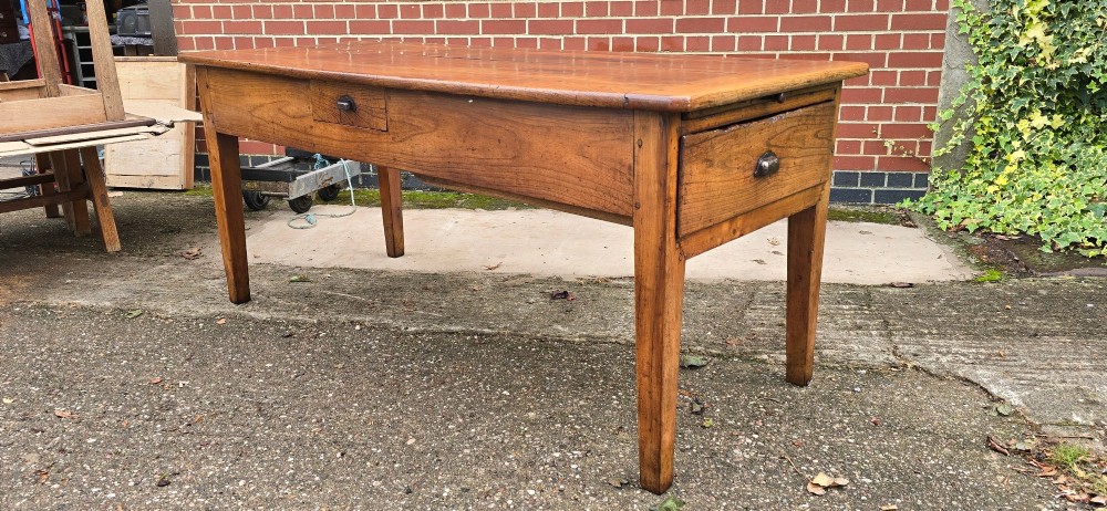 A rectangular French cherry wood refectory dining table featuring a three-plank top, side frieze drawer with metal handle, and square tapered legs. View II