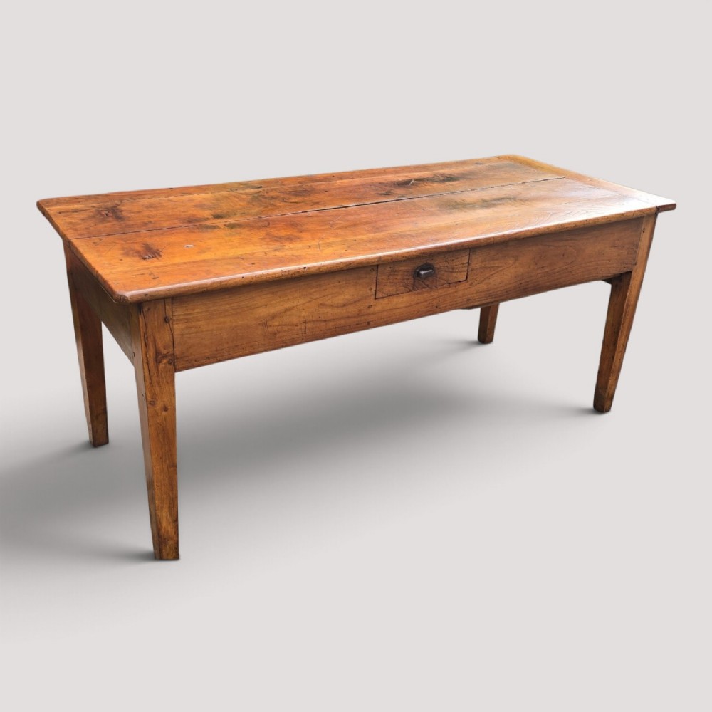 A rectangular French cherry wood refectory dining table featuring a three-plank top, side frieze drawer with metal handle, and square tapered legs. View X