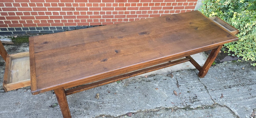 A long solid French oak refectory dining table featuring a plank top and straight legs connected by a low stretcher. View V