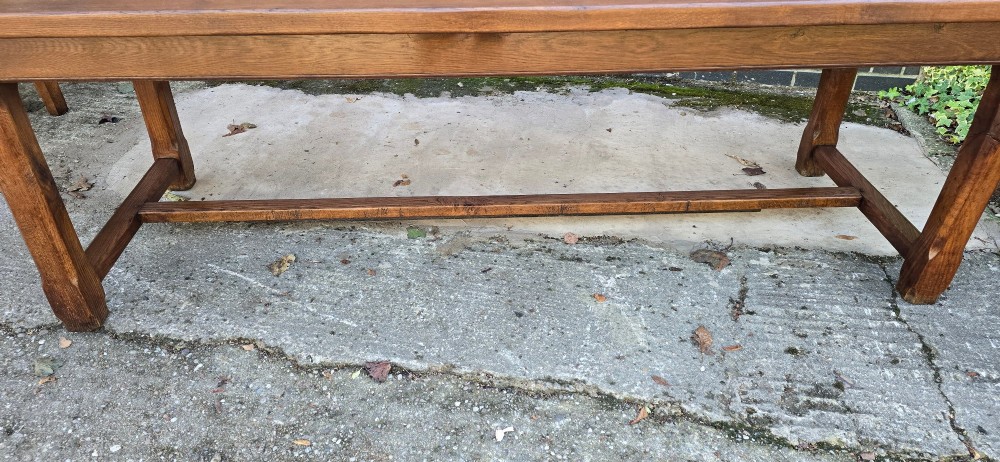 A long solid French oak refectory dining table featuring a plank top and straight legs connected by a low stretcher. View VIII