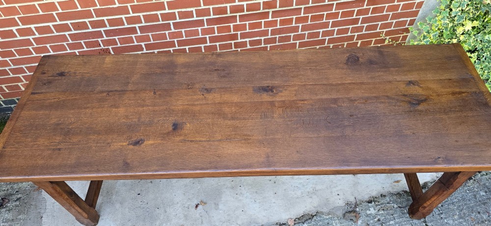 A long solid French oak refectory dining table featuring a plank top and straight legs connected by a low stretcher. View XII