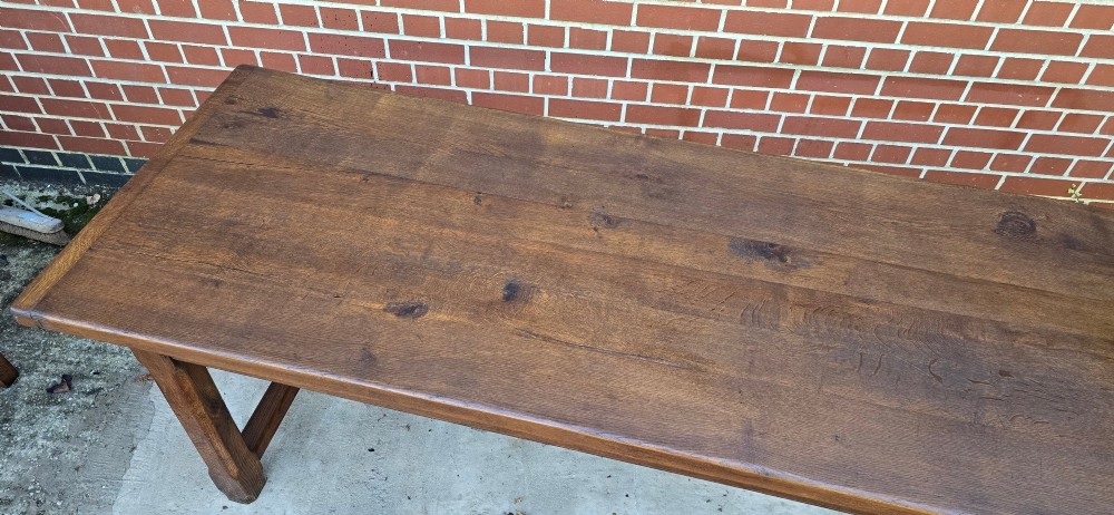 A long solid French oak refectory dining table featuring a plank top and straight legs connected by a low stretcher. View XIII