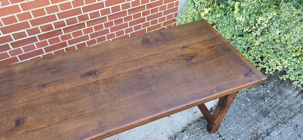 A long solid French oak refectory dining table featuring a plank top and straight legs connected by a low stretcher. View XIV
