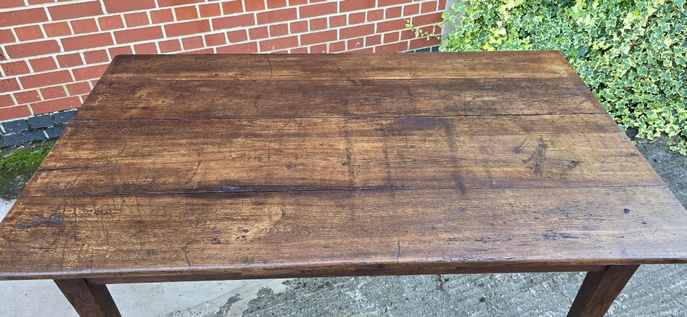 A rectangular rustic oak dining table featuring a frieze drawer with a wooden knob and four square tapered legs. View VIII