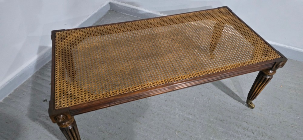 A rectangular Regency bench featuring tan leather upholstery, a reeded dark wood frame, tapered carved legs, and brass castors. View VII