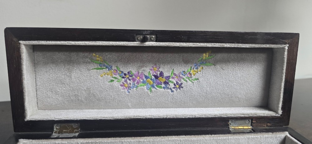 An antique dark wood rectangular glove box featuring foliate marquetry inlay, a curved lid, a key with a silk tassel, and a mother-of-pearl escutcheon. View XI