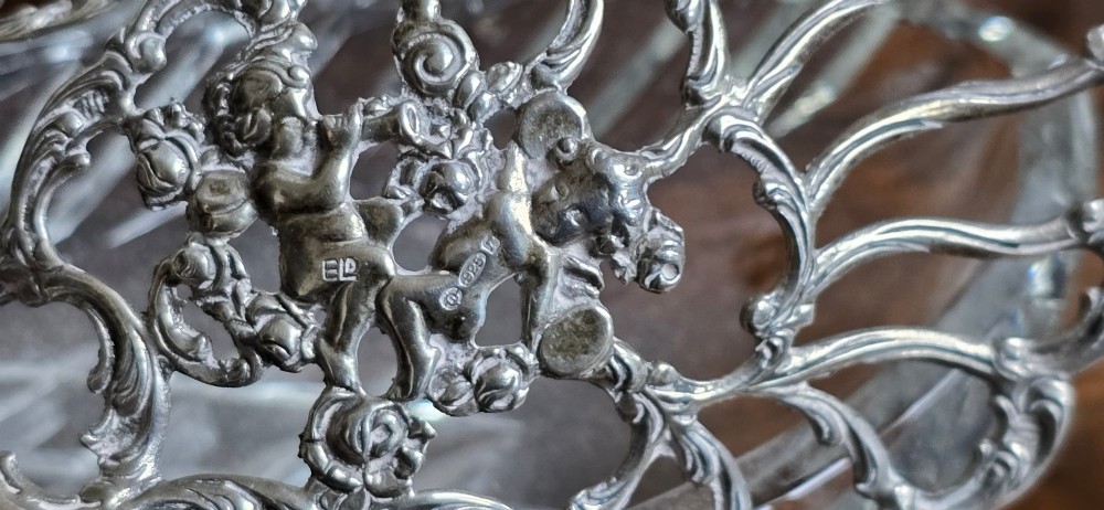 A group of cut glass open salt cellars shaped like swans with silver heads and detailed pierced silver wings. View XV