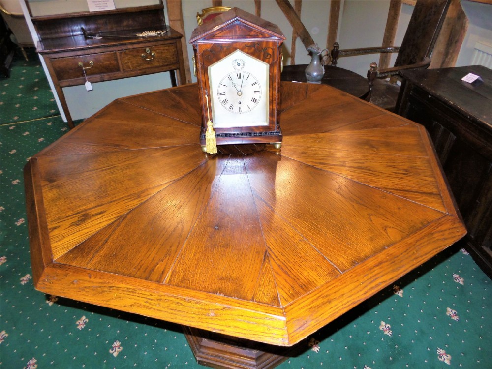 A 19th-century octagonal oak centre table in the Gothic Revival style featuring a carved pedestal base with blind arches and a faceted plinth. View III