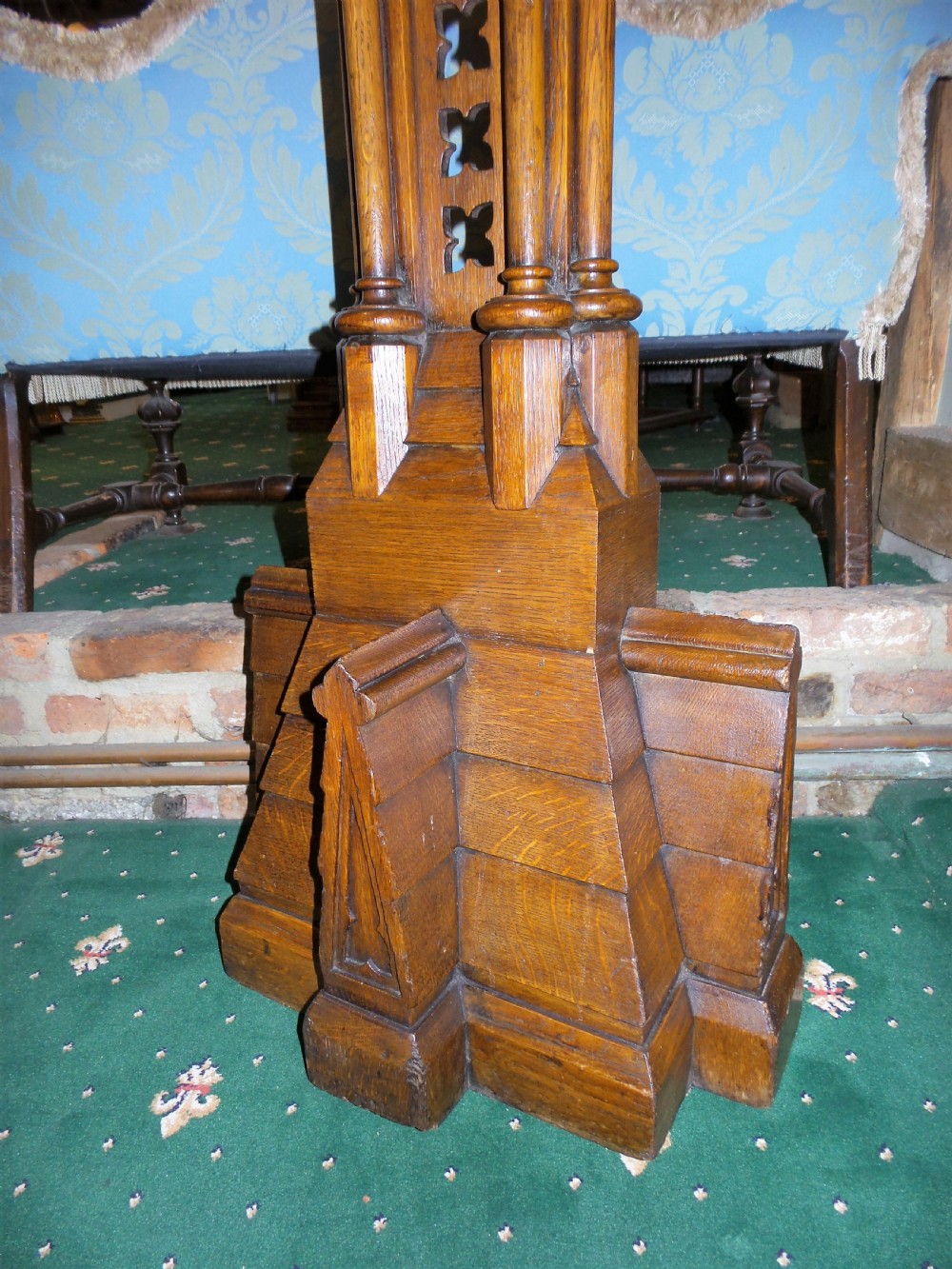A nineteenth-century carved dark oak Gothic Revival lectern featuring a sloped reading surface, pierced tracery shaft, and stepped base. View IV