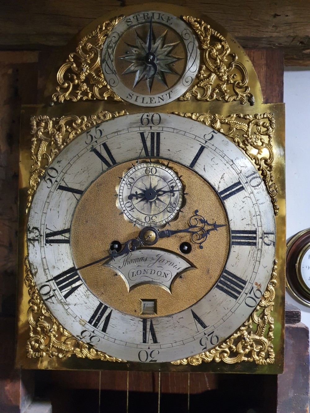 A Georgian flame mahogany eight-day longcase clock featuring a pedimented hood with fluted columns, a brass dial with spandrels, and a tall panelled case. View III