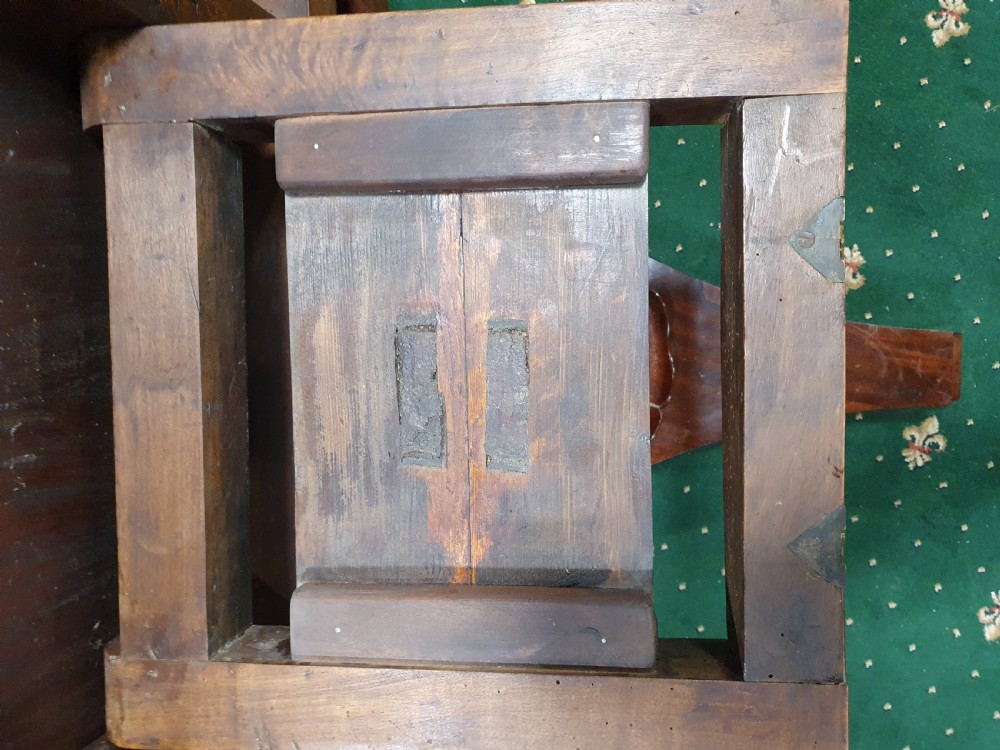 A 19th-century circular flame mahogany breakfast table featuring a polished top supported by a central pedestal base. View V