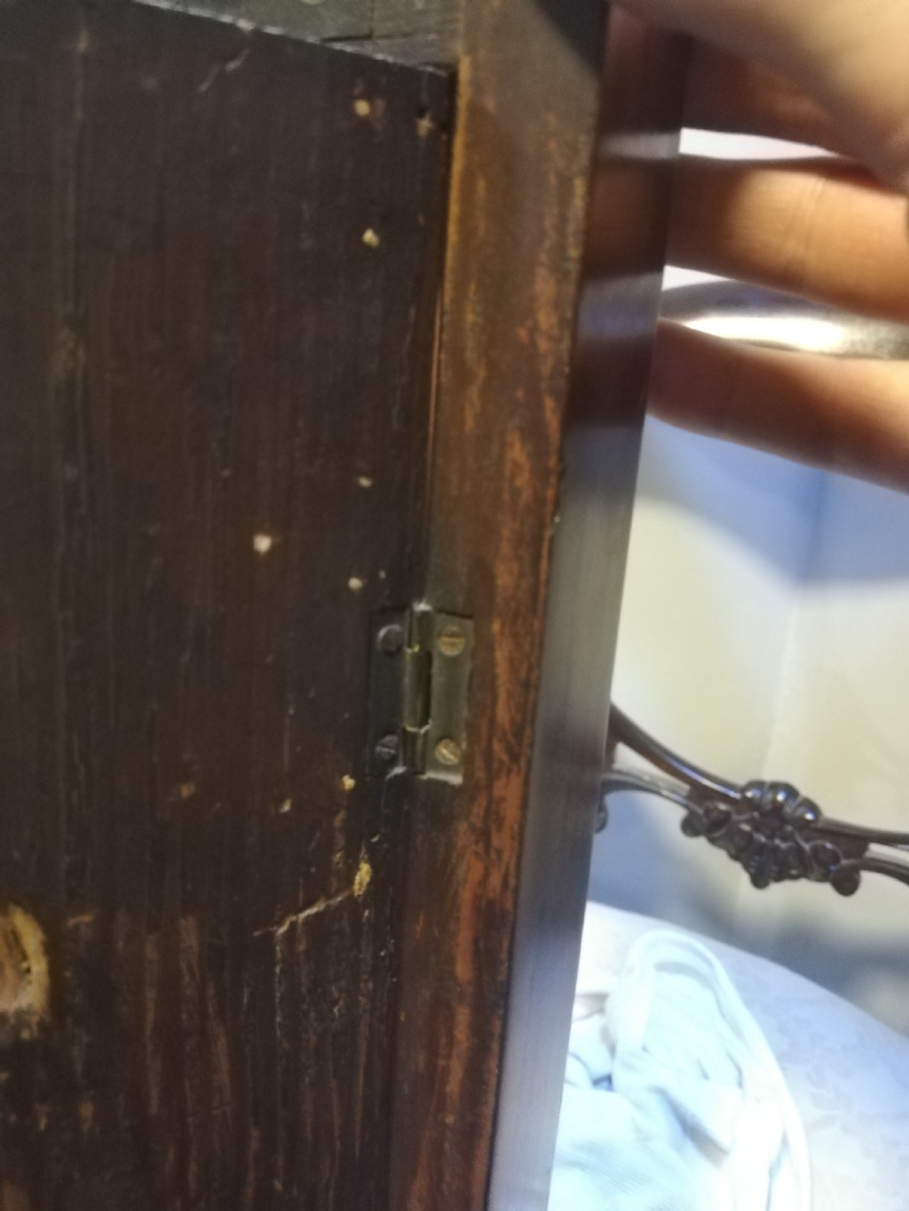 An antique Georgian mahogany wheel barometer featuring a silvered dial with brass bezel, dark wooden casing with inlay, and a pediment top. View XIII