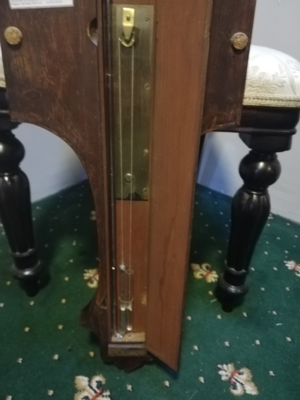 An antique Georgian mahogany wheel barometer featuring a silvered dial with brass bezel, dark wooden casing with inlay, and a pediment top. View XIV