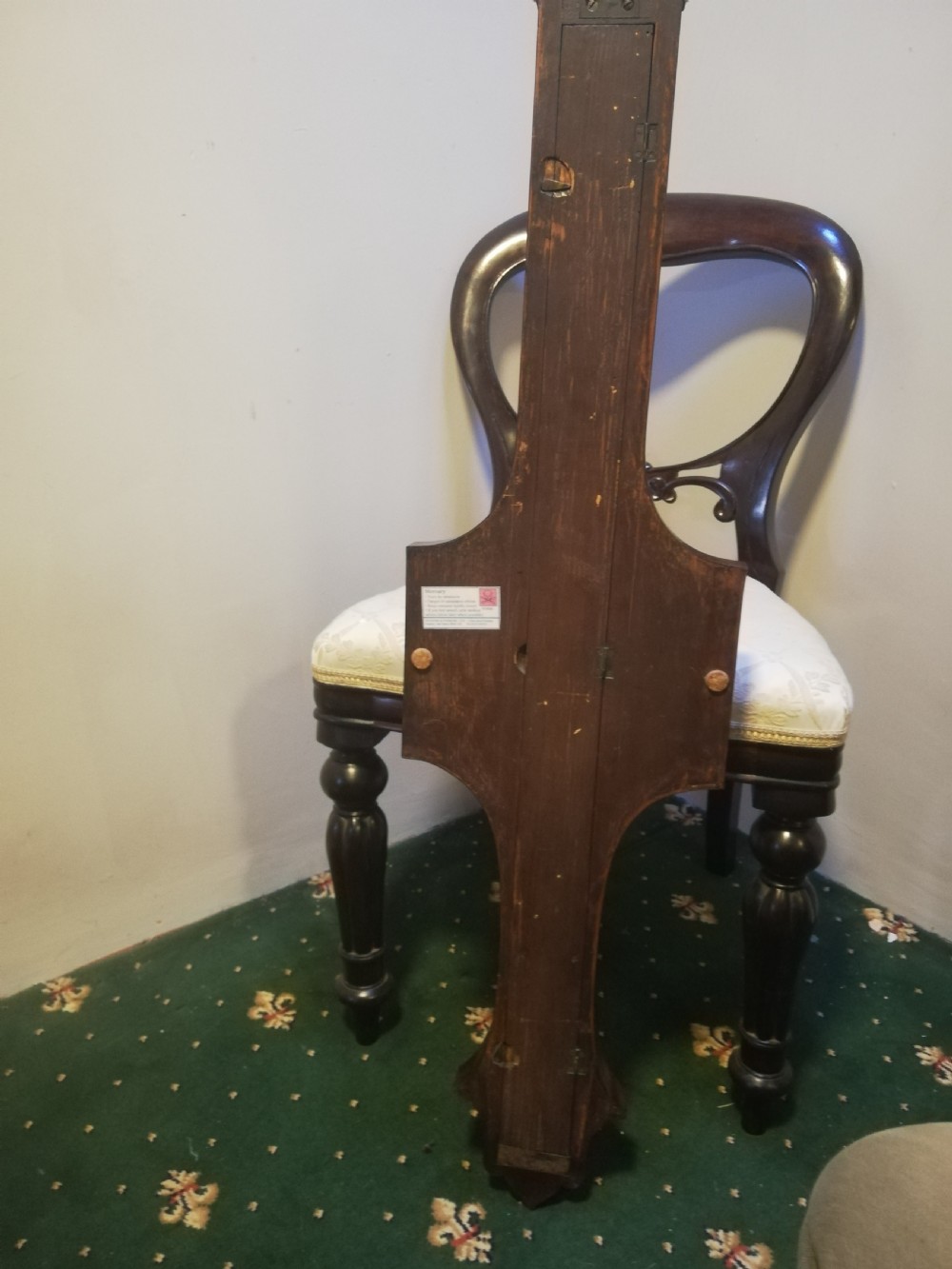 An antique Georgian mahogany wheel barometer featuring a silvered dial with brass bezel, dark wooden casing with inlay, and a pediment top. View XXVIII