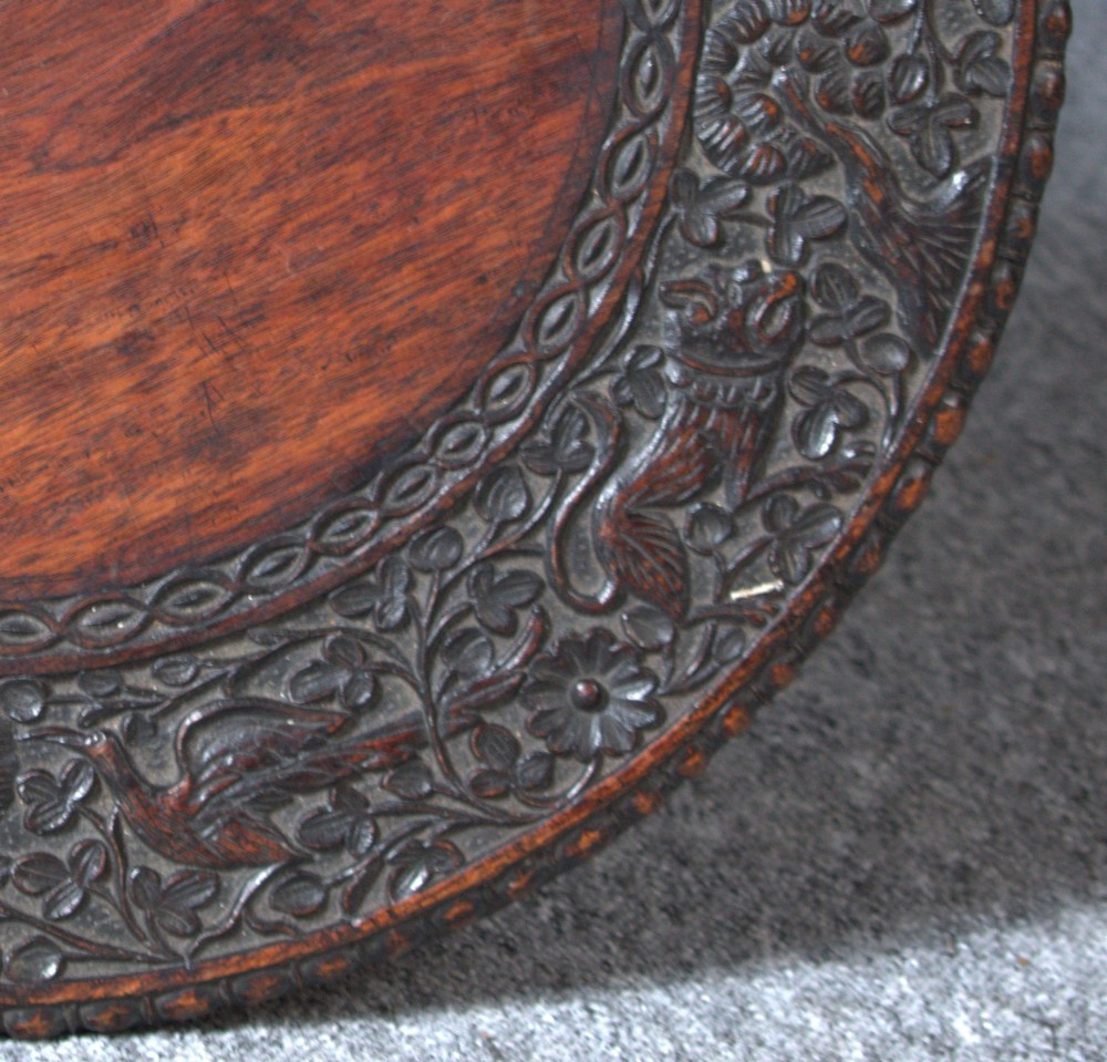 A 19th-century Burmese dark padouk side table with a circular carved top and three bobbin-turned legs forming a tripod base. View VII