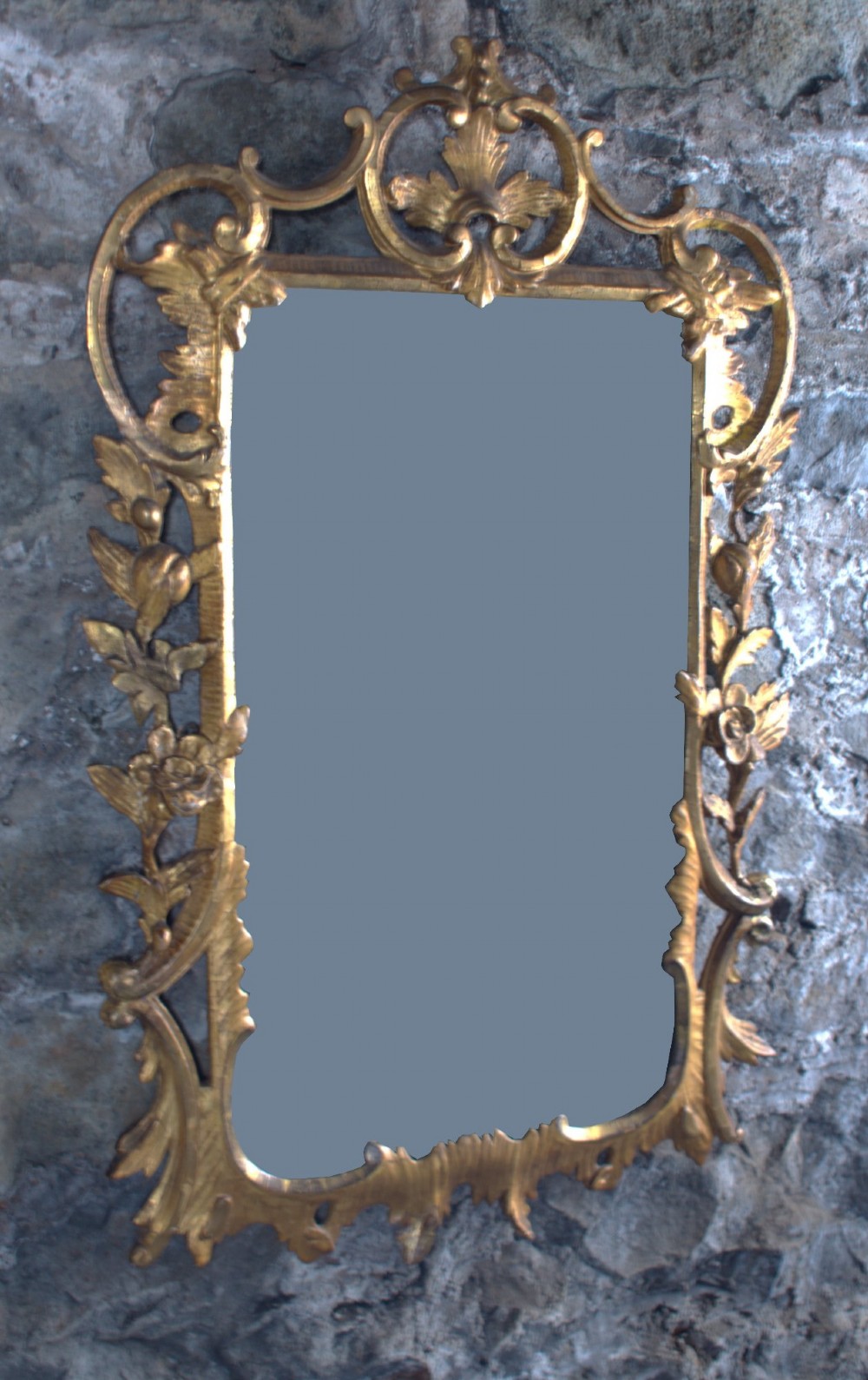 A small George III carved giltwood wall mirror featuring pierced scrolling acanthus leaves, floral motifs, and a rectangular central glass pane. View II