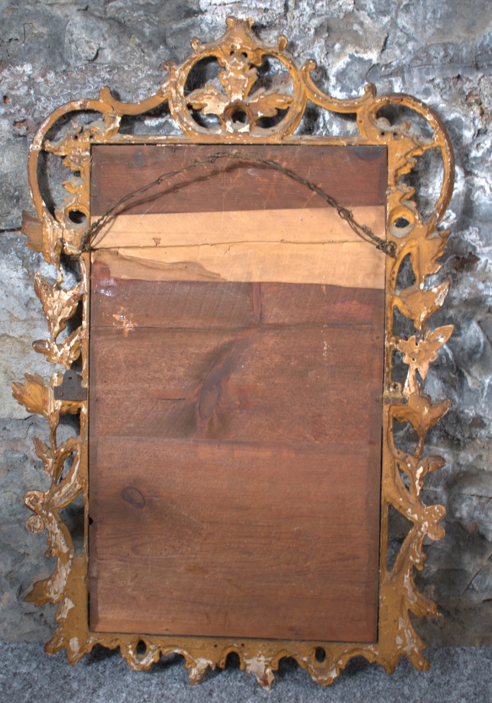 A small George III carved giltwood wall mirror featuring pierced scrolling acanthus leaves, floral motifs, and a rectangular central glass pane. View III