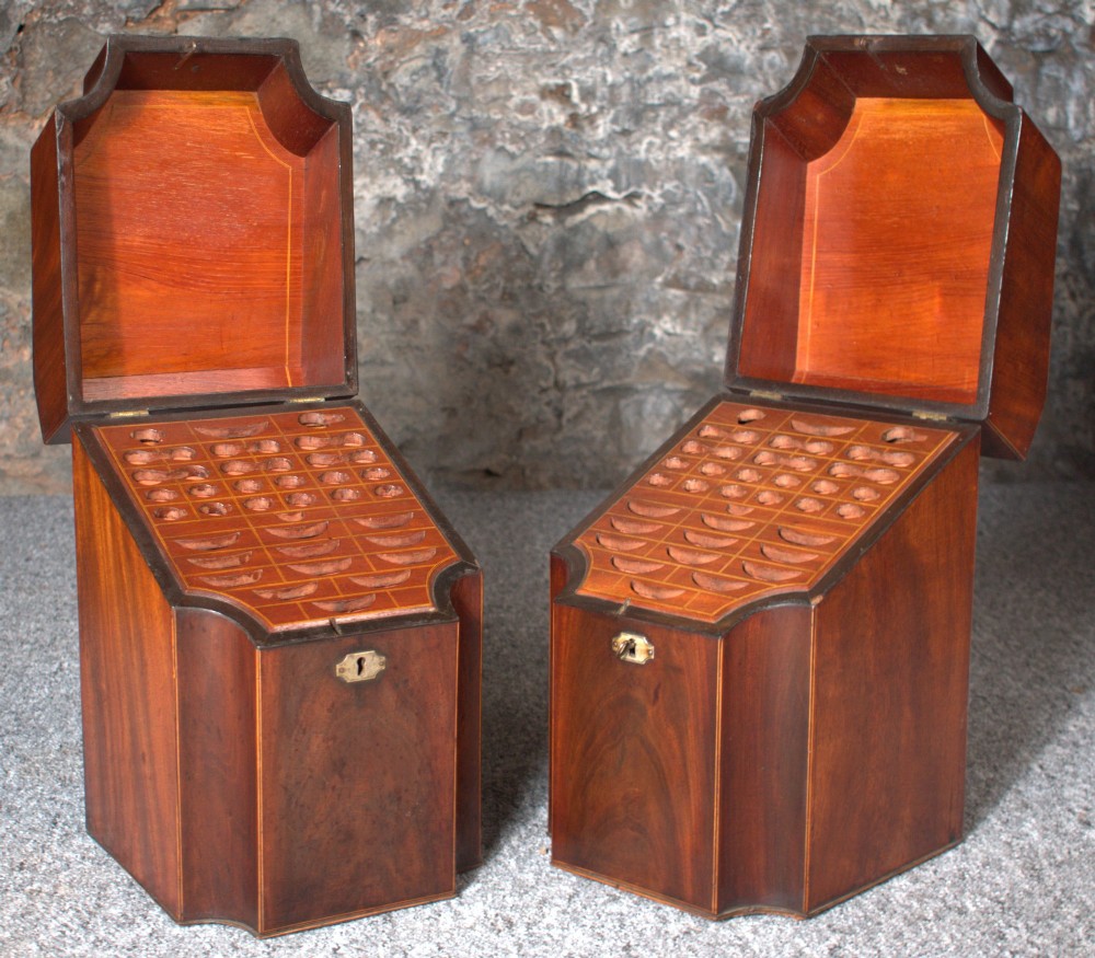 A pair of late eighteenth-century George III mahogany knife boxes featuring sloped lids, serpentine fronts, and brass ring fittings. View II