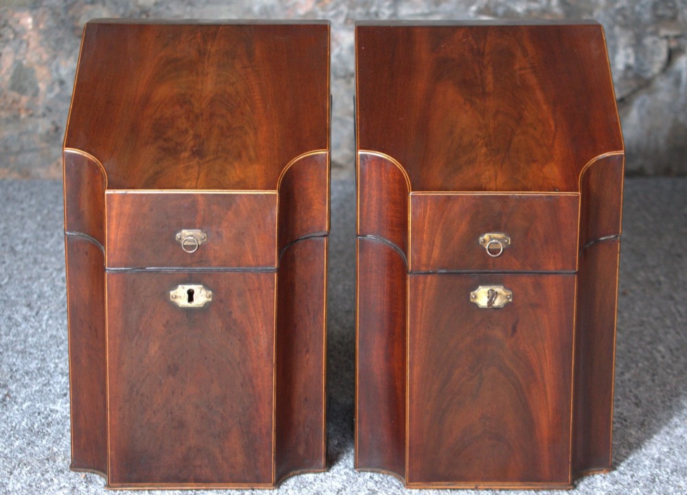 A pair of late eighteenth-century George III mahogany knife boxes featuring sloped lids, serpentine fronts, and brass ring fittings. View III