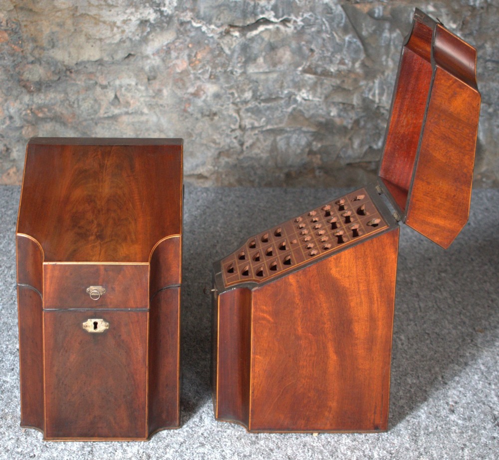 A pair of late eighteenth-century George III mahogany knife boxes featuring sloped lids, serpentine fronts, and brass ring fittings. View IV