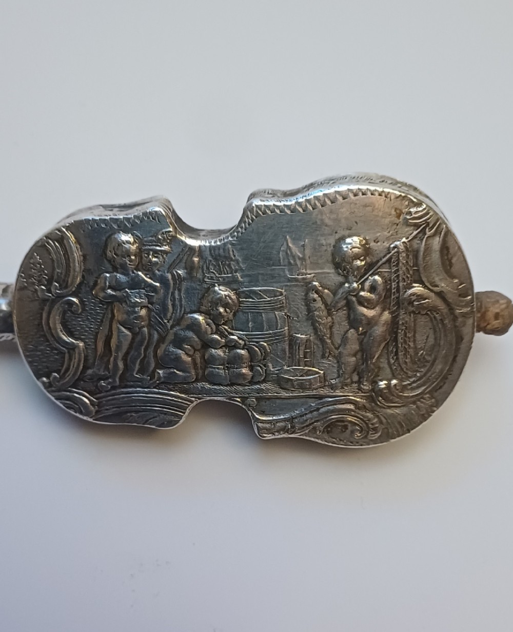 A miniature 19th-century Dutch silver scent bottle crafted in the shape of a violin with engraved scenes and silver wire strings. View VII