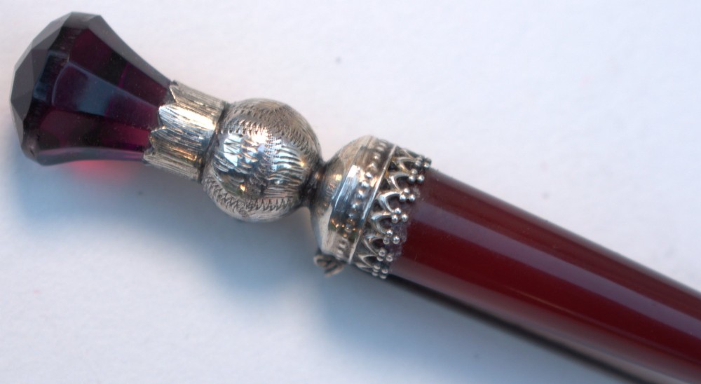 A Victorian Scottish silver and red agate dirk brooch shaped like a dagger with engraved thistle details and a faceted purple stone pommel. View III