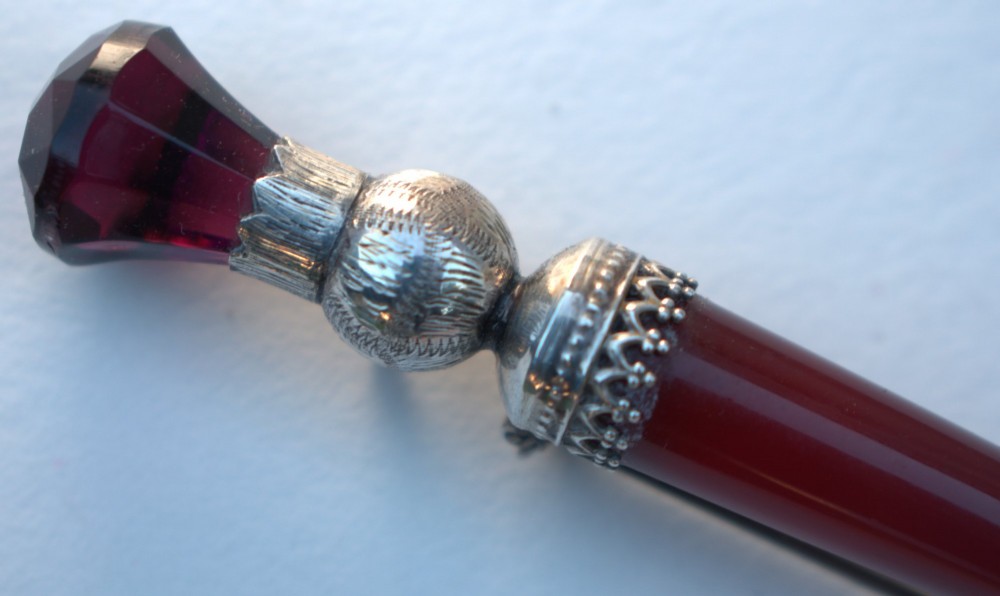 A Victorian Scottish silver and red agate dirk brooch shaped like a dagger with engraved thistle details and a faceted purple stone pommel. View IV