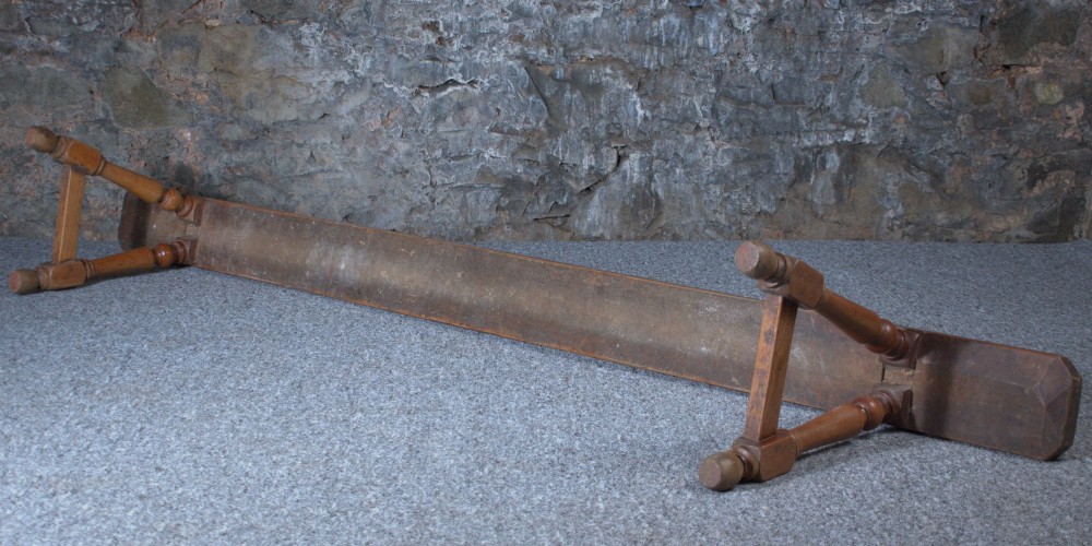 A pair of long 19th-century cherry wood benches with turned trestle legs, stretchers, and smooth timber tops. View VII