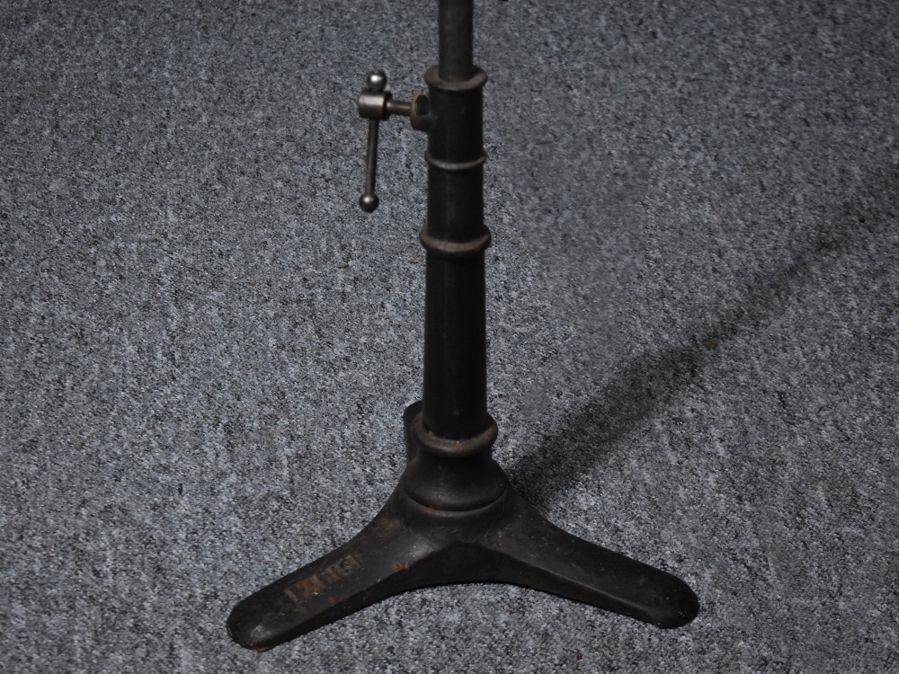 An early 20th-century Bleriot metal searchlight mounted on an adjustable dark metal telescoping floor stand with a cast tripod base. View XI